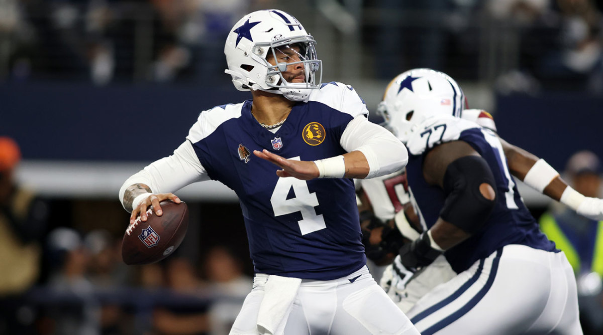 Dak Prescott winds up to throw a pass in the Cowboys’ Thanksgiving throwback jerseys
